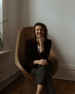 About Bite Me Podcast - Marge pictured sitting in a chair