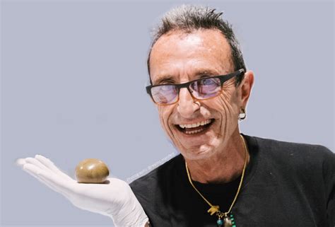 Frenchy Cannoli holding a temple ball.