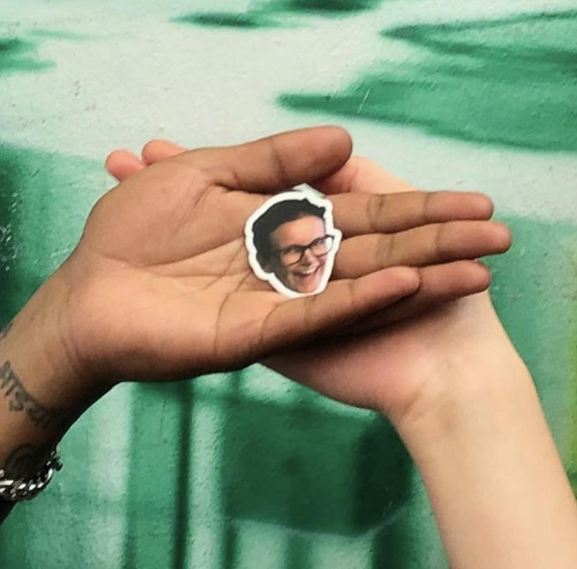 bean salad recipe episode - marge's face sticker held in the palm of a hand