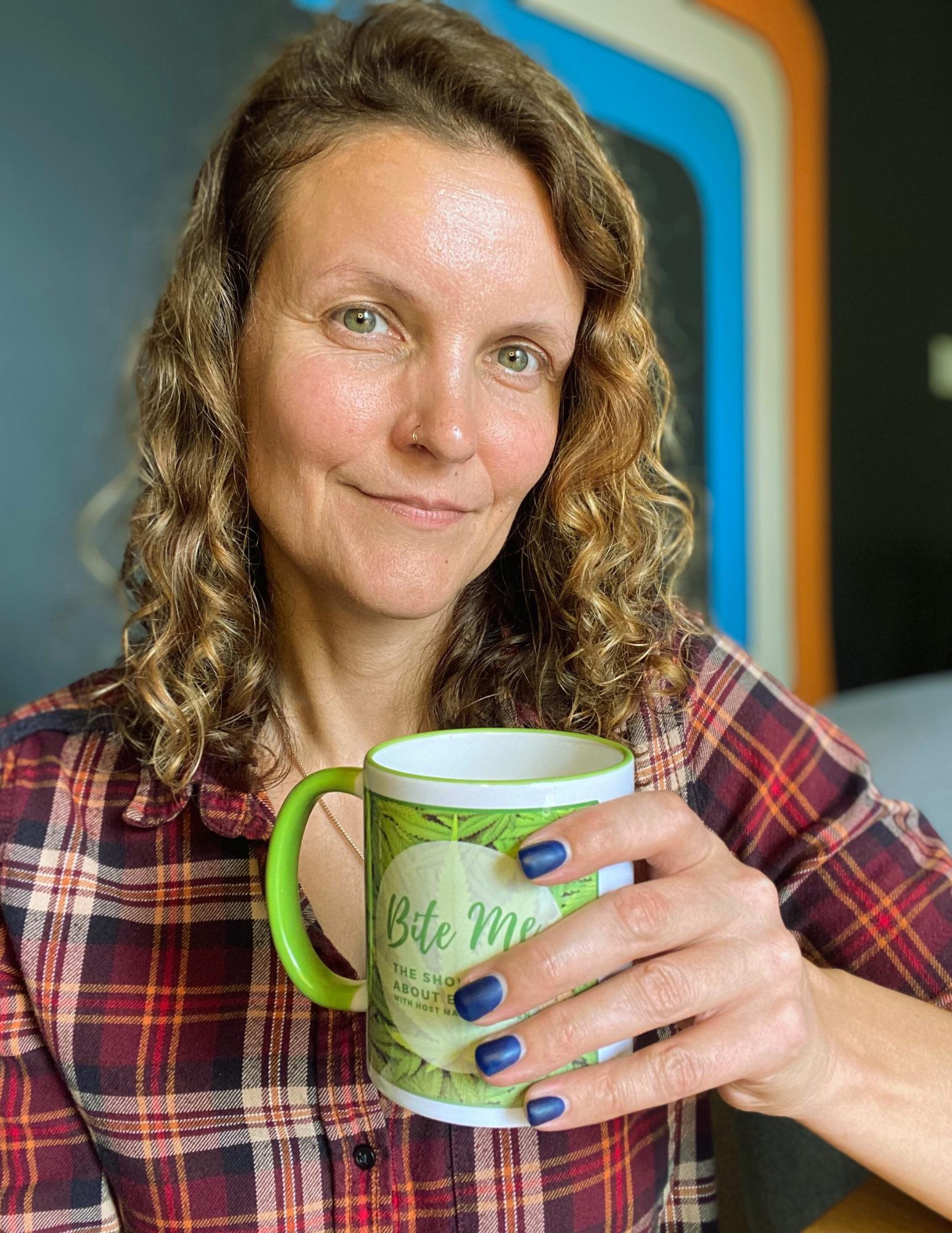 marge holding a mug containing infused hot toddy