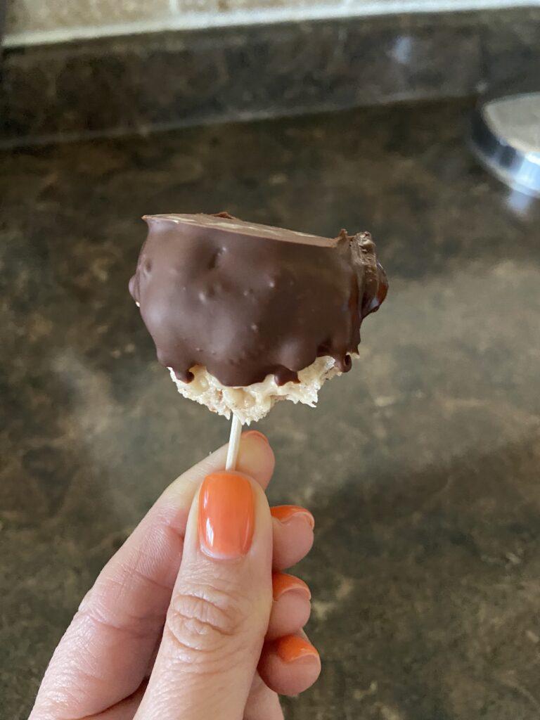 kentucky bourbon ball on a toothpick, dipped in chocolate
